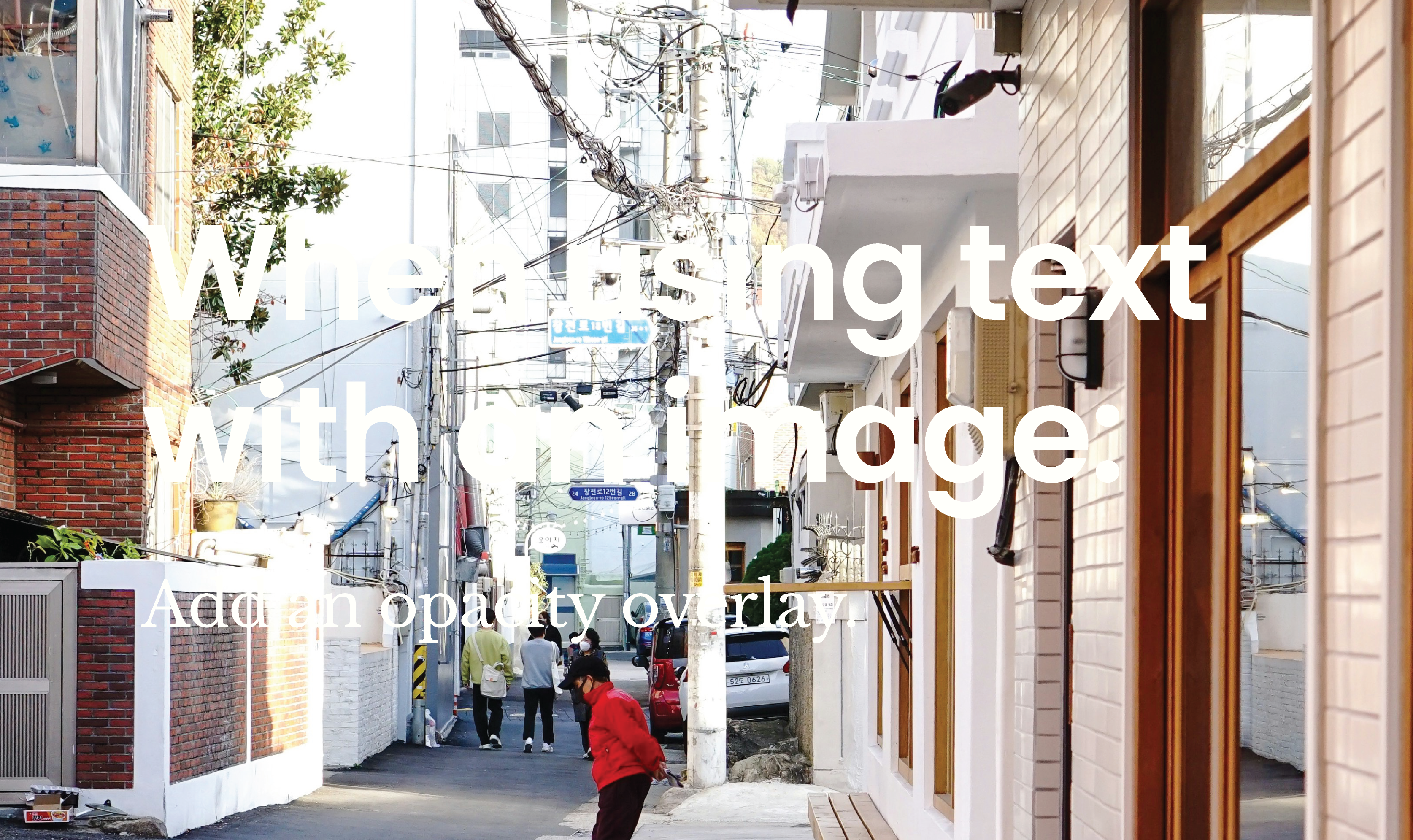 An image of a bright and busy city alleway. The text "When using text with an image: Add an opacity overlay" is difficult to read without the opacity overlay applied.